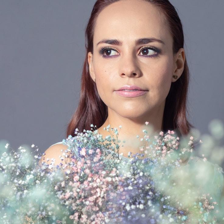 Avery Chen, Lead Design Curator at Moonlit Mountain Association, reviewing corporate floral arrangements